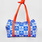 white and blue Scandinavian floral print with red strap and bow