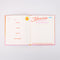 interior memories pages of orange and pink ombre travel journal with white 'endless possibilities' typography across the front