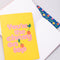 set of three notebook set: dark blue with tulip print, yellow with 'you're the cherry on top' typography, and pink mid century tulips with one opened to show lined paper