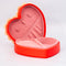side view of red heart shaped jewelry box with pink interior and cream scalloped detail with 'sweet little jewelry' across the front