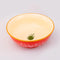 top view of cream interior of red large ceramic serving bowl with light pink garden border and orange rim with green veggie inside