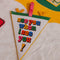 cream pennant luggage tag with colorful 'see you when i see you!' front and pink, yellow and green trim on a towel