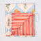 Polyester reversible picnic blanket with garden print on one side, red-and-white stripes on the other, elastic loop closure, 60 by 54 inches.