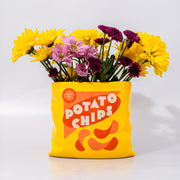 yellow potato chips shaped vase with flowers inside