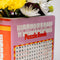 up close of pink word search puzzle book shaped ceramic vase with flowers inside