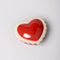 top view of ceramic heart shaped trinket box with white scalloped trim and cursive 'everything' in the inside