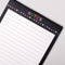 up close of large lined notepad with black trim with colorful 'NOTES' typography and shapes border