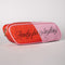 side view of pink and red 'eraser' pencil case with cursive 'ready for anything' on the side