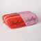 side view of pink and red 'eraser' pencil case with cursive 'ready for anything' on the side