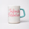 ceramic mug with paper lines and pink cursive 'infinite potenial' typography across the front and light blue handle