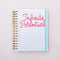 white medium 17-month planner with linked notebook paper ground and pink 'infinite potential' typography and sky blue elastic closure