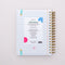 back view of white medium 17-month planner with linked notebook paper ground and pink 'infinite potential' typography and sky blue elastic closure