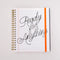 white lined paper large 12-month planner with cursive 'ready for anything' font and orange elastic closure