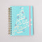 sky blue 12-month large planner with white 'a joy to be around' and light pink elastic closure
