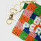 up close of colorful checkered beaded coin pouch with white beaded 'book person' and removable gold hardware