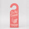 pink bookmark in the shape of a door hanger with white 'do not disturb! book reading in progress' across the front