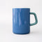 back view of blue ceramic mug with light pink heart and cursive' bookworm' across the front with teal handle and interior