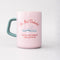 reversed side of light pink ceramic mug with teal handle and 'do not disturb! i am currently reading a really good book!' typography on both sides