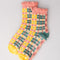 coral, teal, cream and yellow plaid chenille socks with coral ruffle top and cream grip bottoms