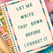 cream mini notebook with colorful striped border and teal 'let me write that down before i forget it' on a tulip print notebook
