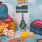 passport holder with colorful mountain scene and 'greeting from paradise' across the front surrounded by other items