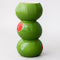 side view of three green olives stacked vase