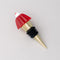 gold brass wine stopper with red jello mold topper and black rubber stopper