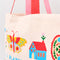 up close of cream tote bag with two-tone pink and red handles and 'I'd rather be reading' typography with colorful folk inspired graphics
