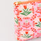 side view of pink folk floral quilted pouch
