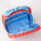 opened pink and red vertical stripe toiletry bag with light blue bow handle