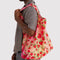 model carrying multicolor big baggu with all over strawberry print