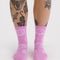 model wearing pink crew socks with white smiley print