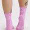 back view of model wearing pink crew socks with white smiley print