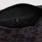interior zipper of charcoal grey dopp kit with black ditsy floral