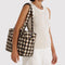 model carrying blurred brown gingham everyday cloud bag