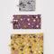 set of 3 wildwood flat pouch set: grey floral, plum floral, and yellow floral