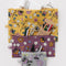 set of 3 wildwood flat pouch set: grey floral, plum floral, and yellow floral with items inside
