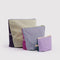 set of three go pouch set: small lavender/deep sea, medium light blue/fuchsia pink, and large plum/pale yellow