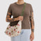 model carrying medium nylon crescent bag with green and pink abstract floral print