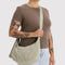 model carrying celadon (sage) medium crescent bag