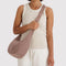 model carrying toasted almond medium crescent bag