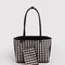 reversed side of reversible black tote with black and white gingham interior