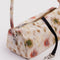 up close of nylon loaf bag with cream ground and abstract floral print
