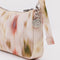 up close of cream pochette with abstract floral