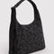 side view of charcoal shoulder bag with black ditsy floral