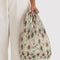 model carrying cream abstract floral pleated baggu