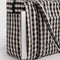 cream and black gingham small cloud carry-on with a laptop sticking out