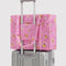 bright pink small cloud carry on bag with gold melting star print on a suitcase