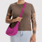 model carrying deep fuchsia small crescent bag