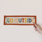 model holding colorful rectangle banner with orange trim and 'GO OUTSIDE' in alternating colors
